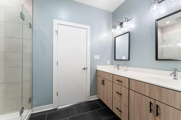 a bathroom with a double vanity sink and mirror