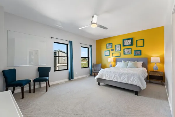 a spacious bedroom with a bed and a table in it