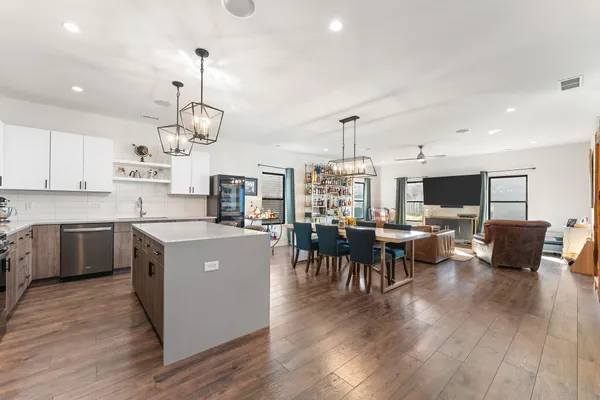 a large kitchen with a table and chairs