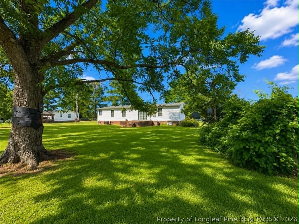 4435 Tartt's Mill Road Wilson, NC 27893 - Photo 17 of 23 a view of a house with a yard