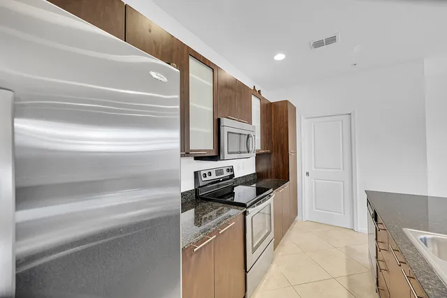 a kitchen with stainless steel appliances a refrigerator and a stove