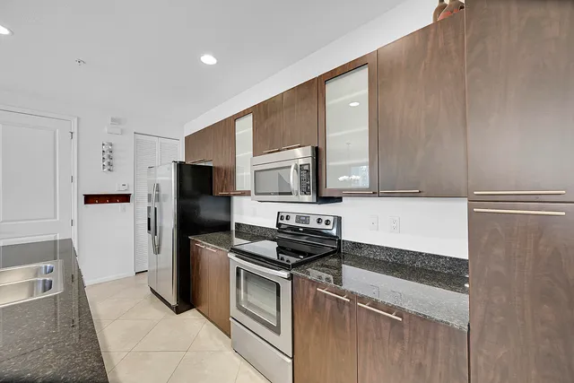 a kitchen with a refrigerator stove and microwave