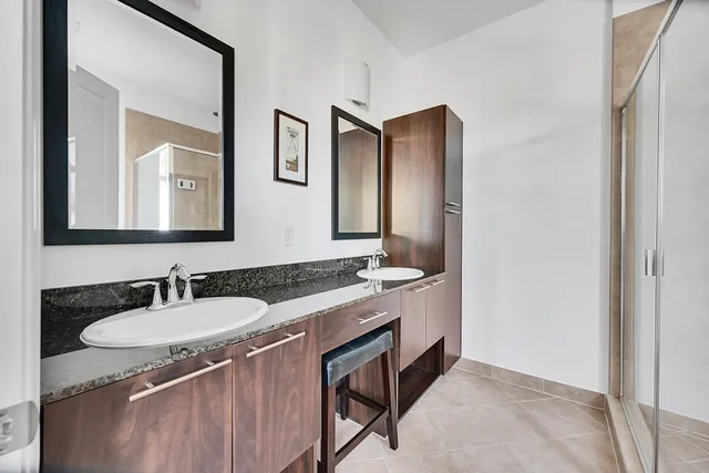 a bathroom with a granite countertop sink and a mirror