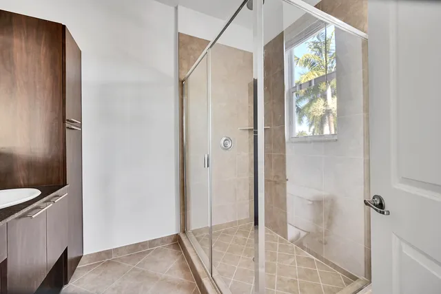 a bathroom with a shower and a sink