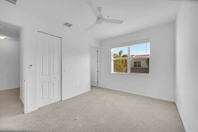 an empty room with windows and closet