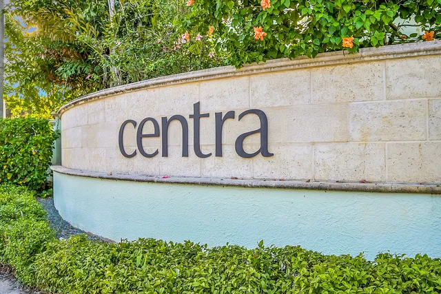 a sign that is on a pole on a wall