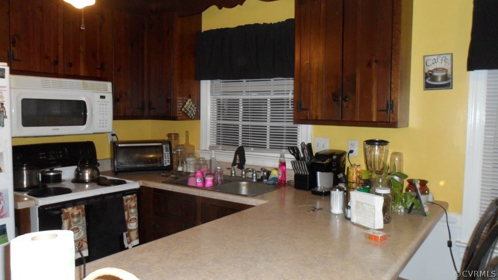 9748 Kendrick Road Chesterfield, VA 23236 - Photo 4 of 18 a kitchen with a stove a sink and a microwave