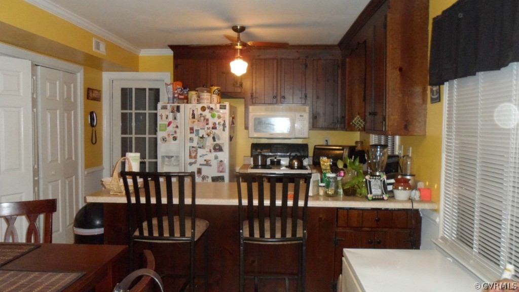9748 Kendrick Road Chesterfield, VA 23236 - Photo 5 of 18 a kitchen with sink refrigerator dining table and chairs
