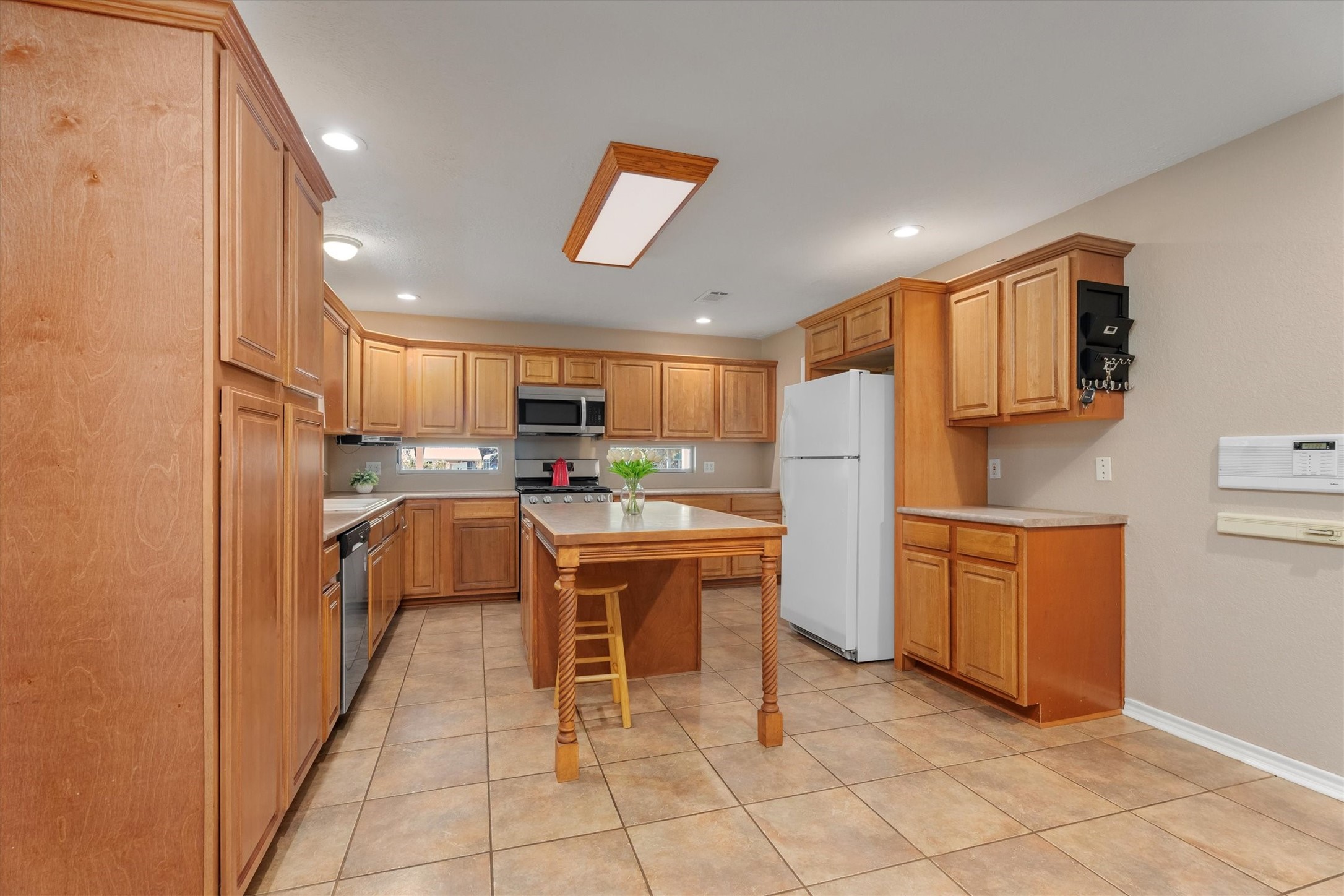 10205 Fostoria Road Cleveland, TX 77328 - Photo 13 of 44 a kitchen with stainless steel appliances granite countertop a refrigerator and a stove top oven