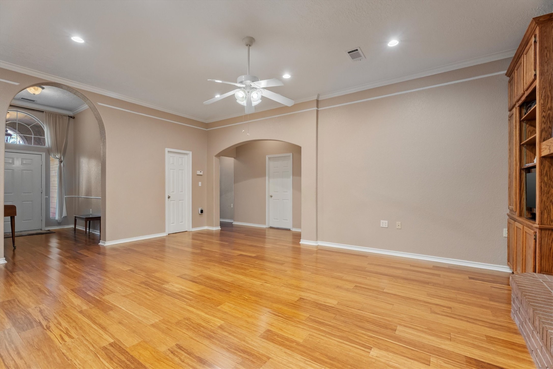 10205 Fostoria Road Cleveland, TX 77328 - Photo 17 of 44 an empty room with wooden floor and chandelier