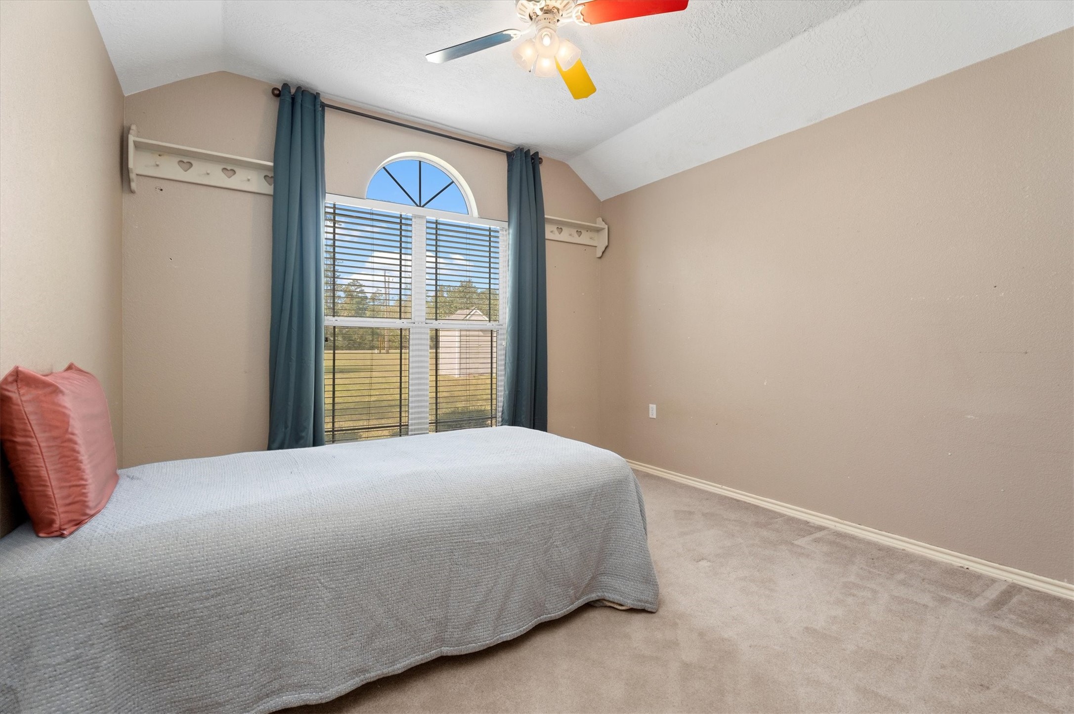 10205 Fostoria Road Cleveland, TX 77328 - Photo 21 of 44 a bedroom with a bed and a window