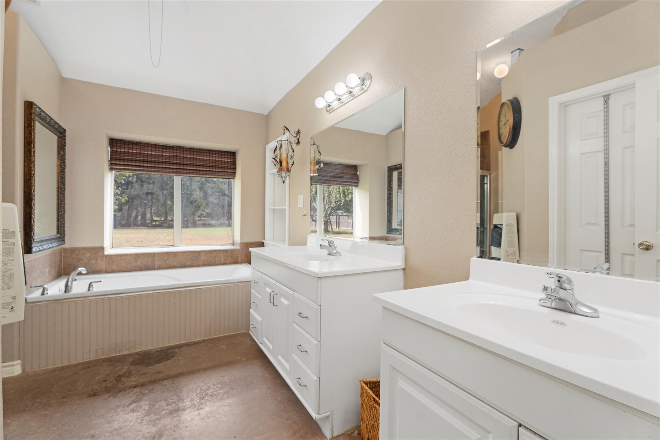 10205 Fostoria Road Cleveland, TX 77328 - Photo 25 of 44 a bathroom with a tub sink and mirror