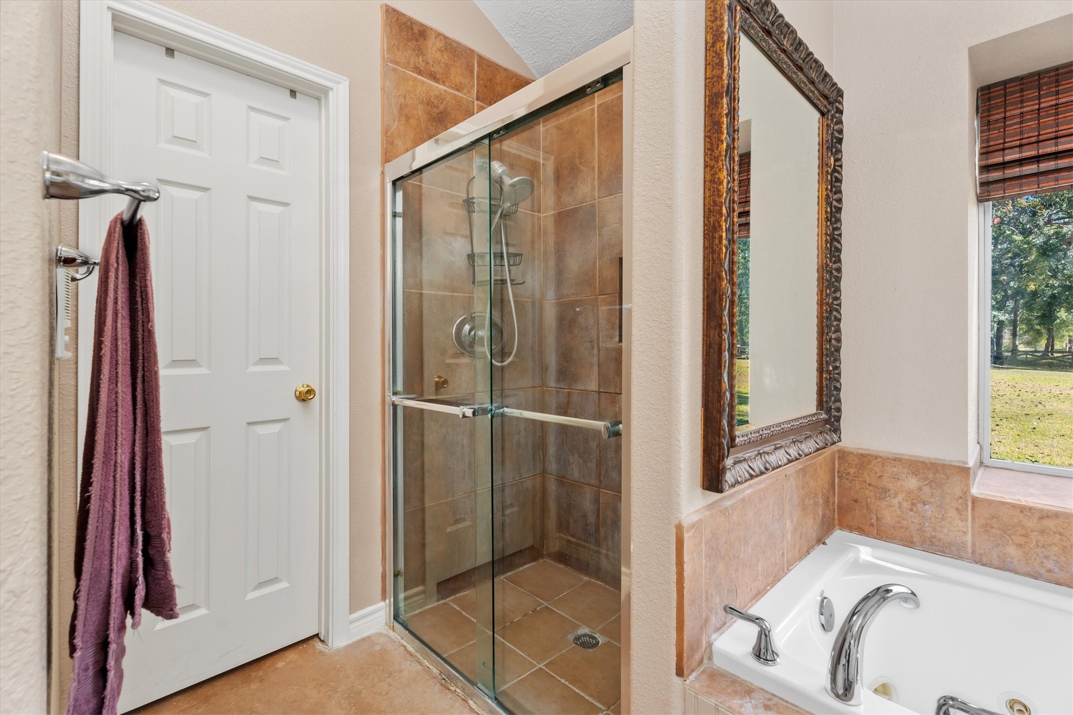 10205 Fostoria Road Cleveland, TX 77328 - Photo 26 of 44 a bathroom with a tub and a shower