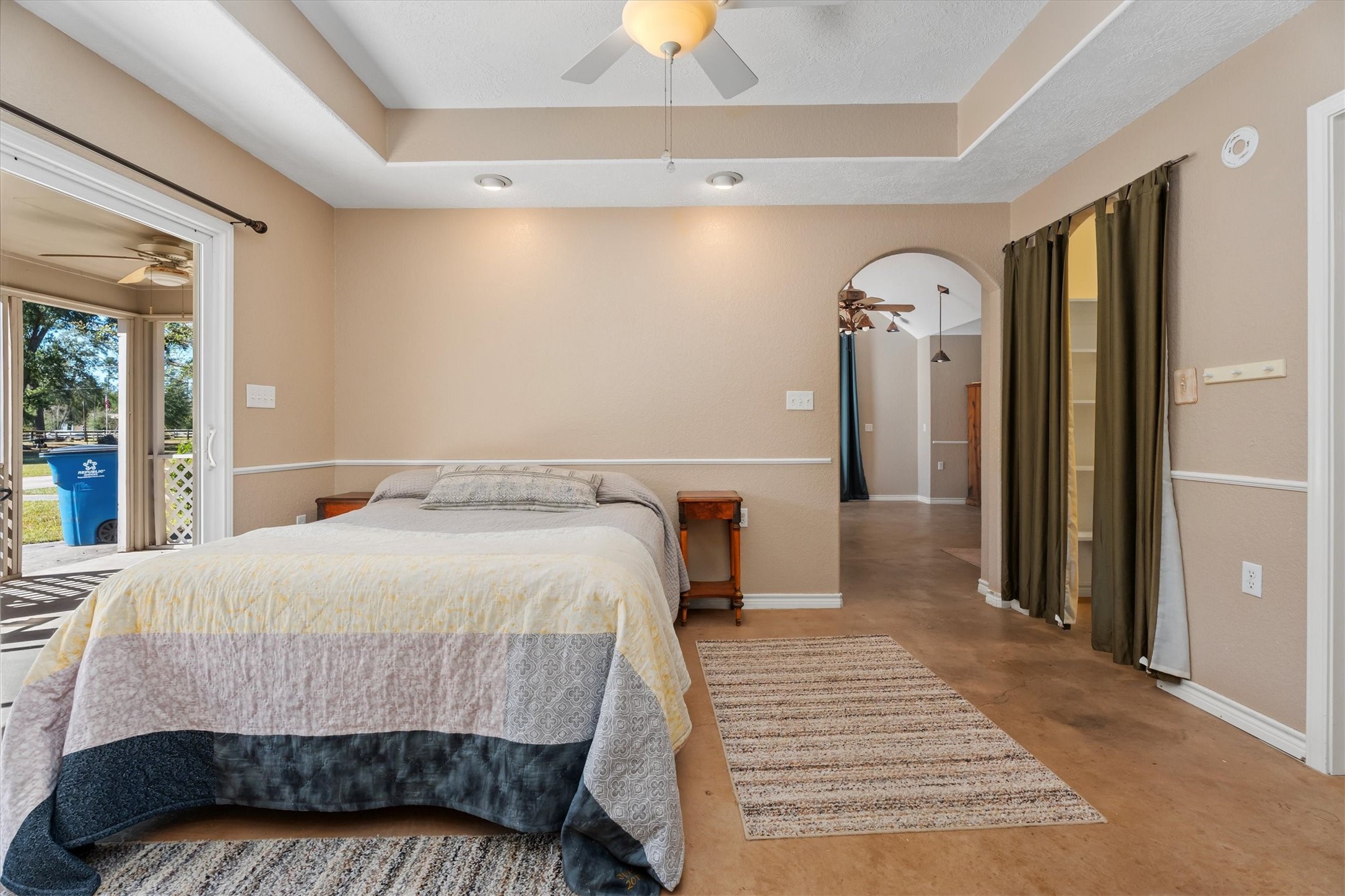 10205 Fostoria Road Cleveland, TX 77328 - Photo 32 of 44 a bedroom with a bed and a chandelier