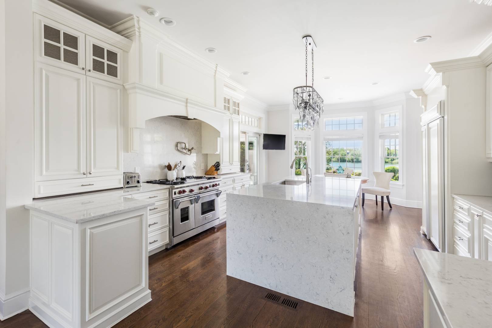 19 Kellis Way Bridgehampton, NY 11932 - Photo 8 of 26 a large kitchen with stainless steel appliances granite countertop a stove and a wooden floors