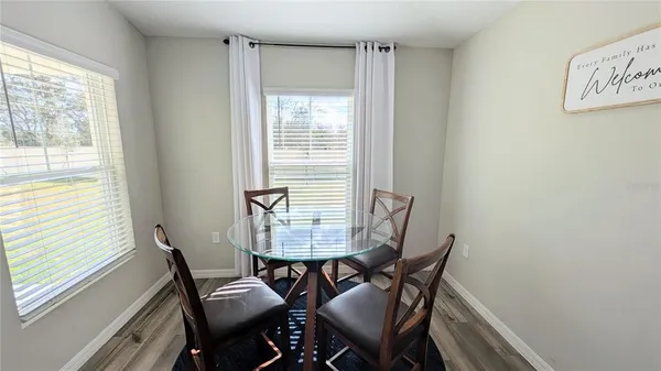 a view of a dining room with furniture and a window