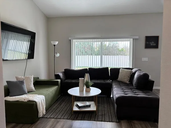 a view of a dining room with furniture and wooden floor
