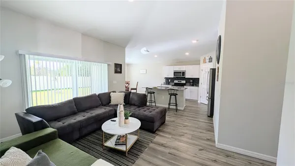 a living room with furniture and a large window