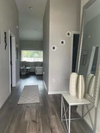 a bedroom with a bed and painting on the wall