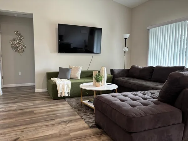a living room with furniture and a flat screen tv