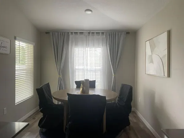 a view of a dining room with furniture window and outside view