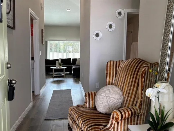 a living room with furniture and a chair