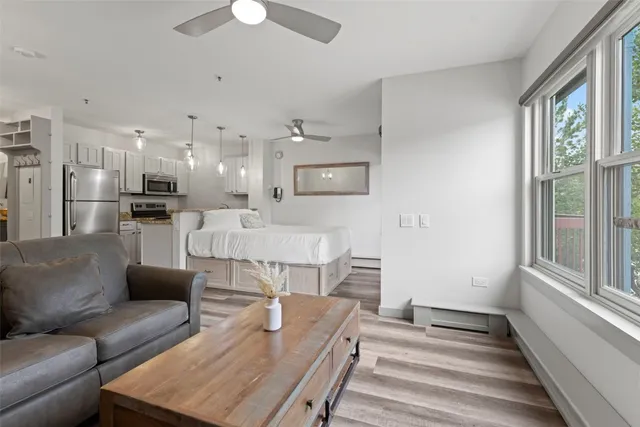 a living room with furniture and a chandelier