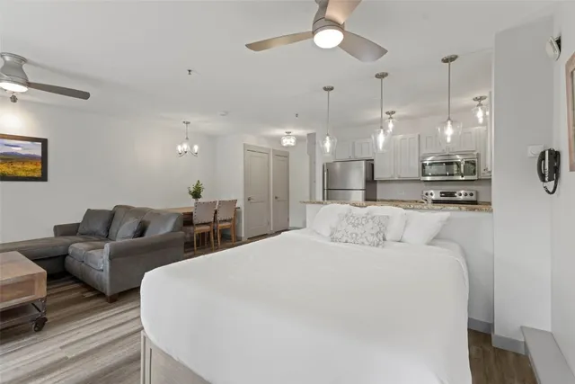 a large bedroom with a bed and a chandelier