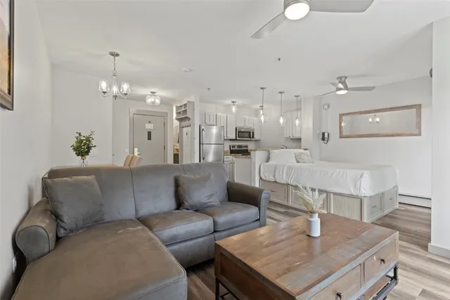 a living room with furniture and a chandelier