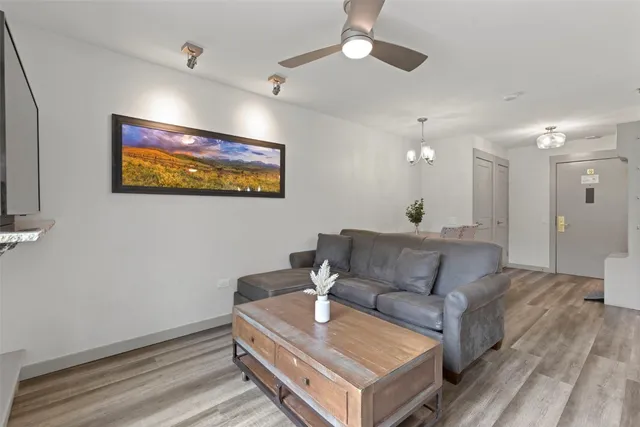 a living room with furniture and a ceiling fan