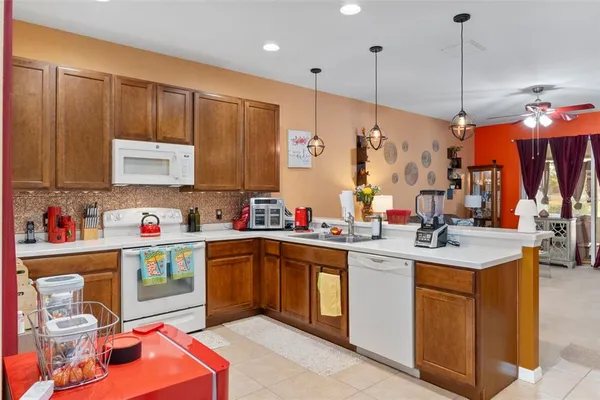 a kitchen with kitchen island a sink stove and cabinets