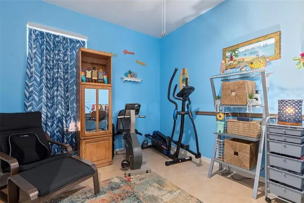 a bedroom with bed and a chandelier