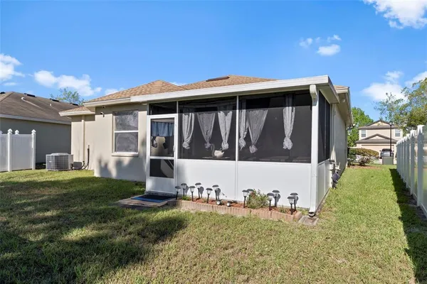 a view of a ocean with a big yard and large trees