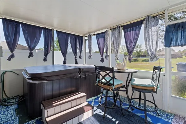 a living room with furniture a window and a flat screen tv