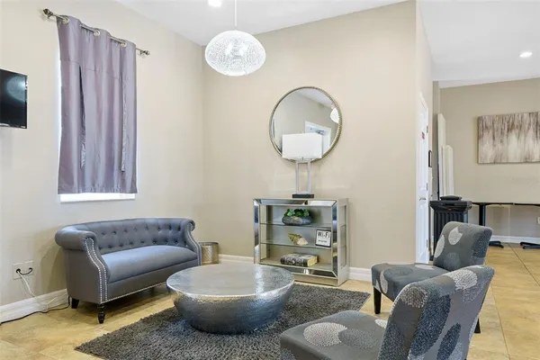 a living room with furniture and kitchen view
