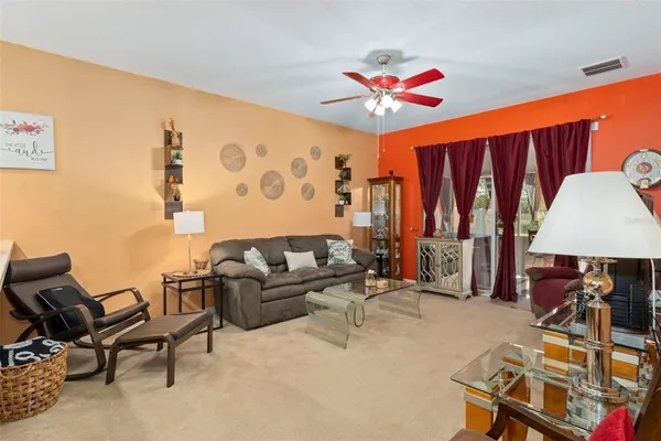 a living room with furniture a lamp and a projector