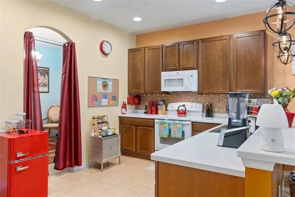 a kitchen that has a sink and a stove in it