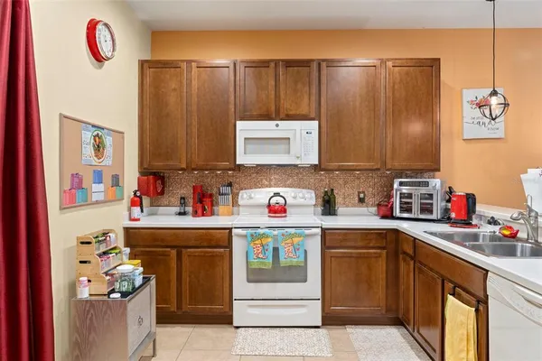 a kitchen with kitchen island cabinets a sink and a stove