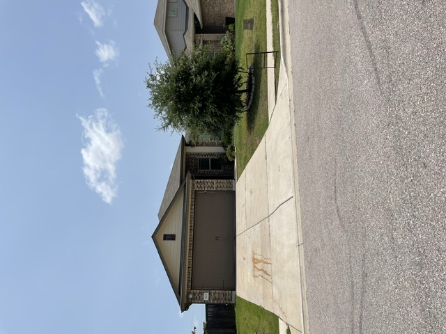 12401 Amber Lynn Path Manor, TX 78653 - Photo 18 of 33 A classic brick exterior offers enduring curb appeal and a welcoming presence.