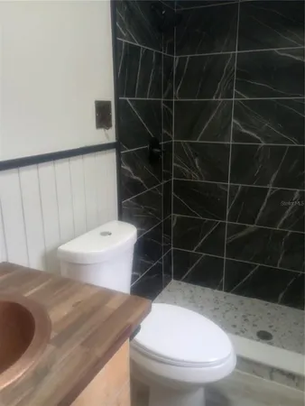 a bathroom with a toilet and a shower
