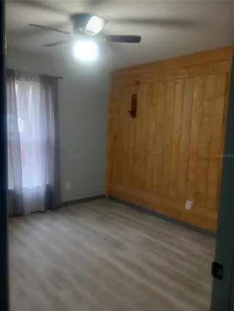 a view of a hallway with wooden shelves