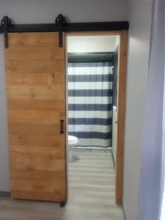 a view of hallway with wooden floor