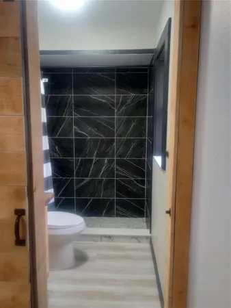 a view of a kitchen with a sink and a mirror