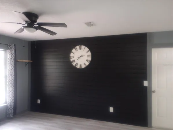 a view of a hallway with a chandelier fan