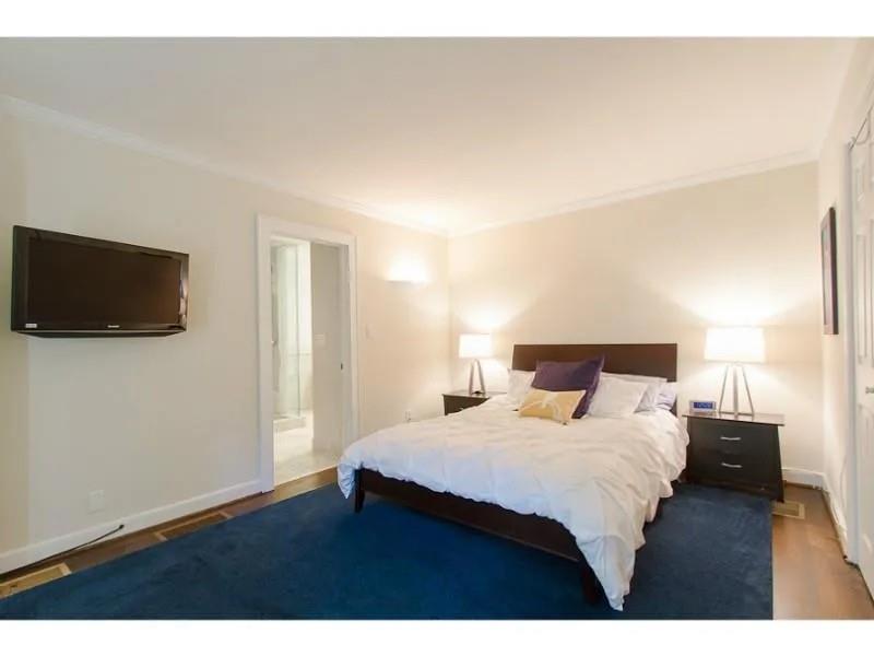 1916 Greystone Road Northwest Atlanta, GA 30318 - Photo 20 of 24 a bedroom with a bed and a flat screen tv