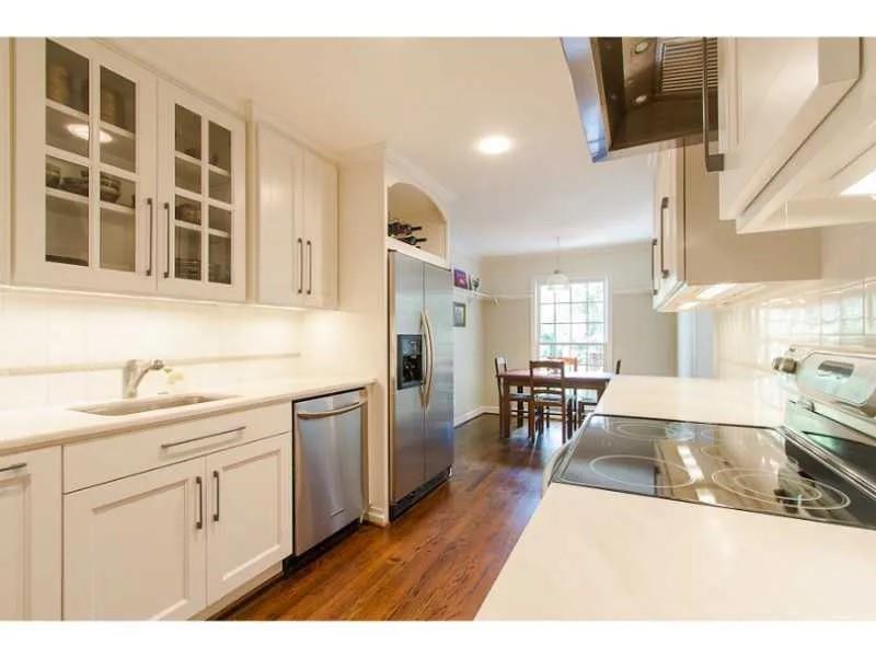 1916 Greystone Road Northwest Atlanta, GA 30318 - Photo 6 of 24 a open kitchen with stainless steel appliances kitchen island granite countertop a sink and cabinets