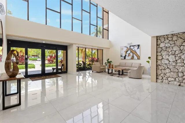a living room with furniture and a floor to ceiling window