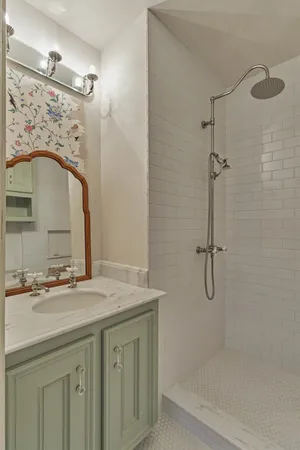 a bathroom with a sink vanity and a mirror