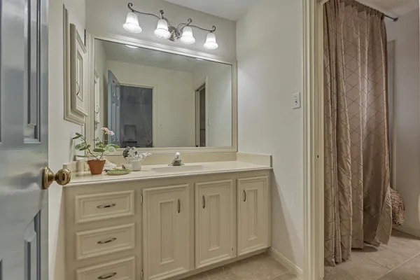 a bathroom with a double vanity sink and a mirror
