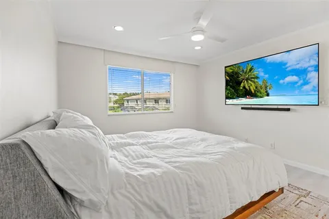 a bedroom with a bed and a painting on the wall